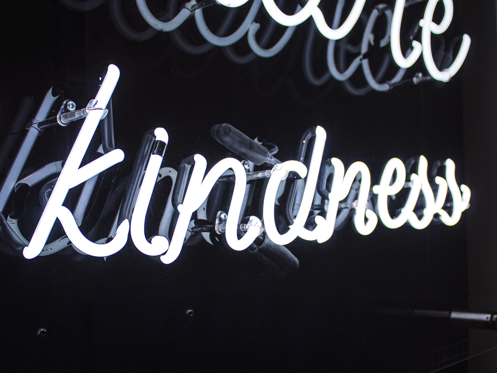 Ride Culture closeup of illuminated neon sign "kindness"