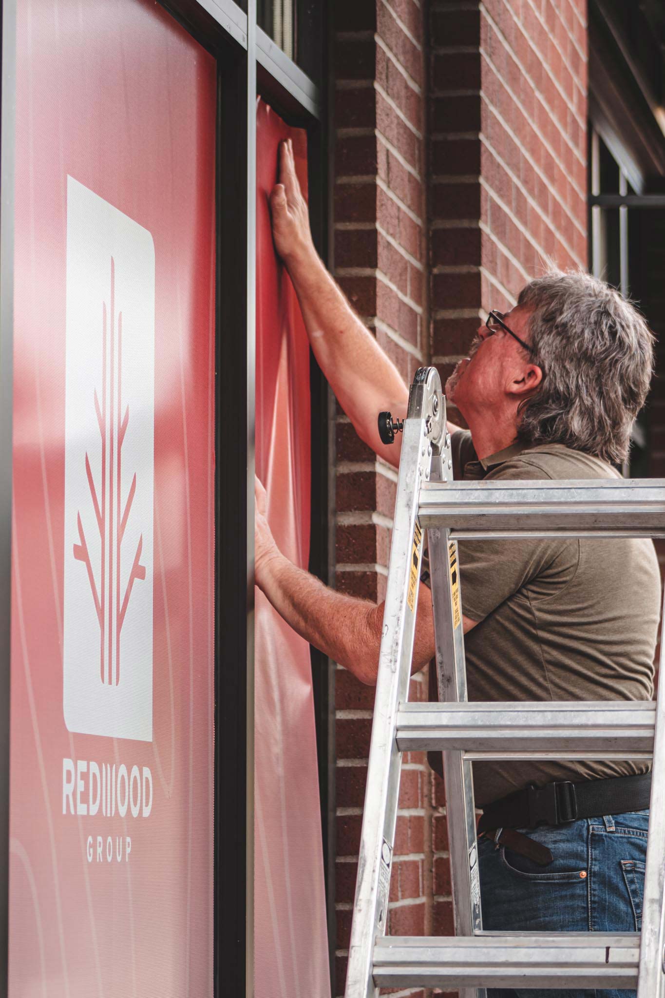 development-redwood-group-exp-realty-window-graphics-install