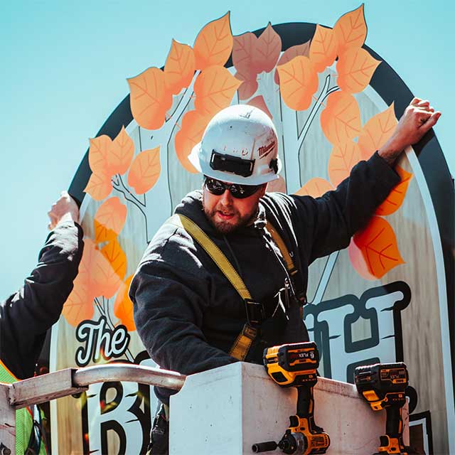 Eric Drommer installing a sign